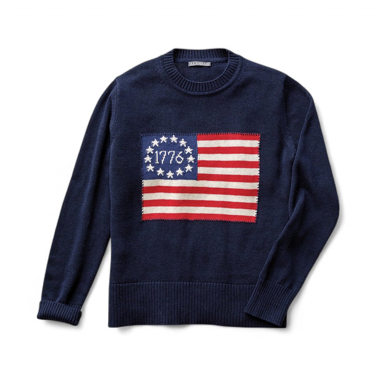 cotton cashmere sweater, inspired by the original American flag, is surrounded by a whip stitch
boarder on a navy background