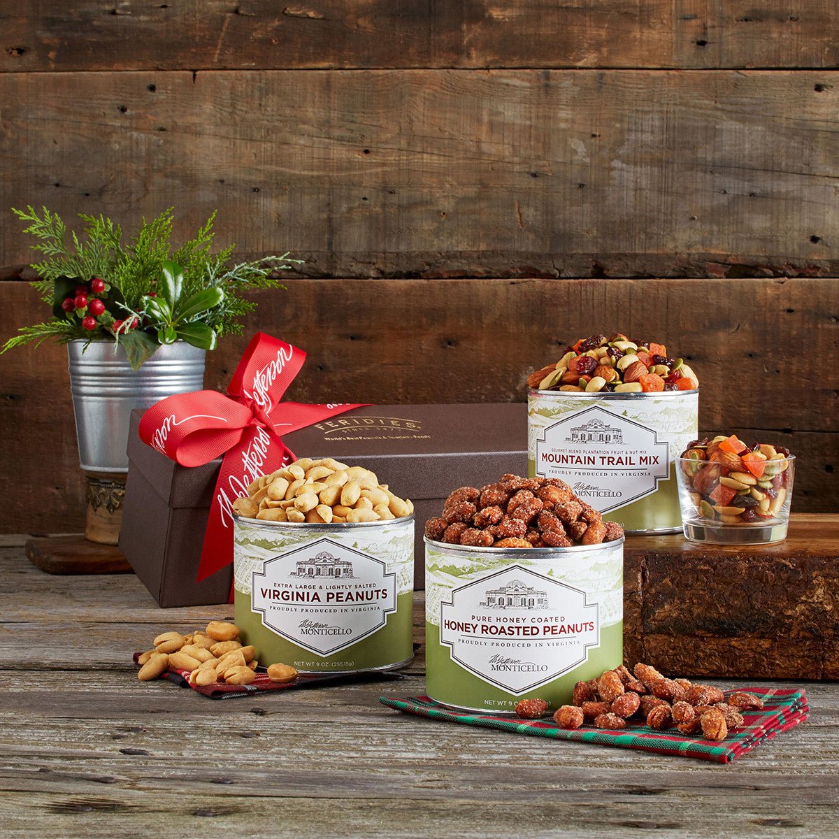 Canisters of three types of Virginia peanuts: salted, honey roasted, and trail mix  
